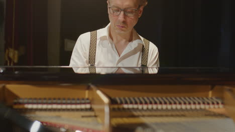 virtuoso pianist playing grand piano on stage