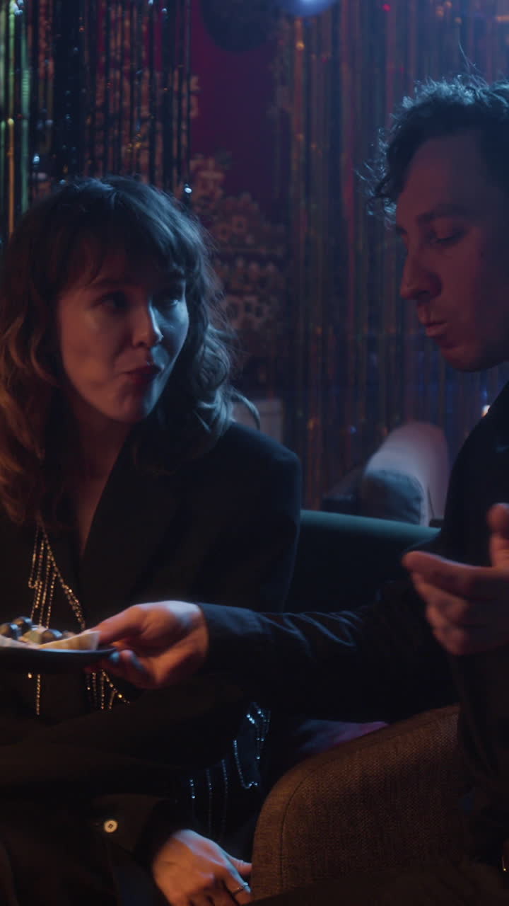 People eating tarts at a party