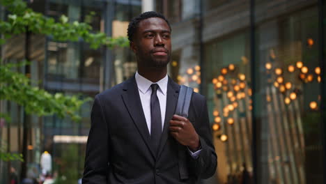 Young-Businessman-Wearing-Suit-Standing-Outside-Offices-In-The-Financial-District-Of-The-City-Of-London-UK-Shot-In-Real-Time