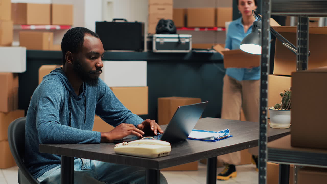 Employees packing boxes at shipping warehouse