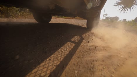 the front wheels powertrain system of the 4 wheels off road drive light truck driving on dirt and dust ground
