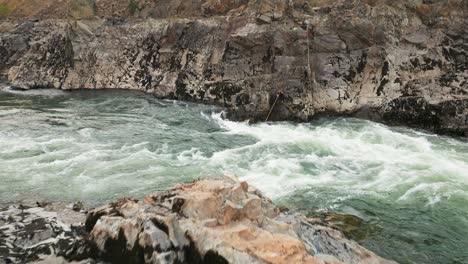 A-drone-shot-of-traditional-first-nations-fishing-on-a-river-in-British-Columbia