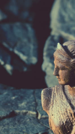 close-up of a weathered stone statue of a woman's head