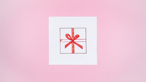 auf einem weißen stück papier erscheint eine zeichnung einer geschenkkiste aus craftpapier, die mit einem roten band gebunden ist.
