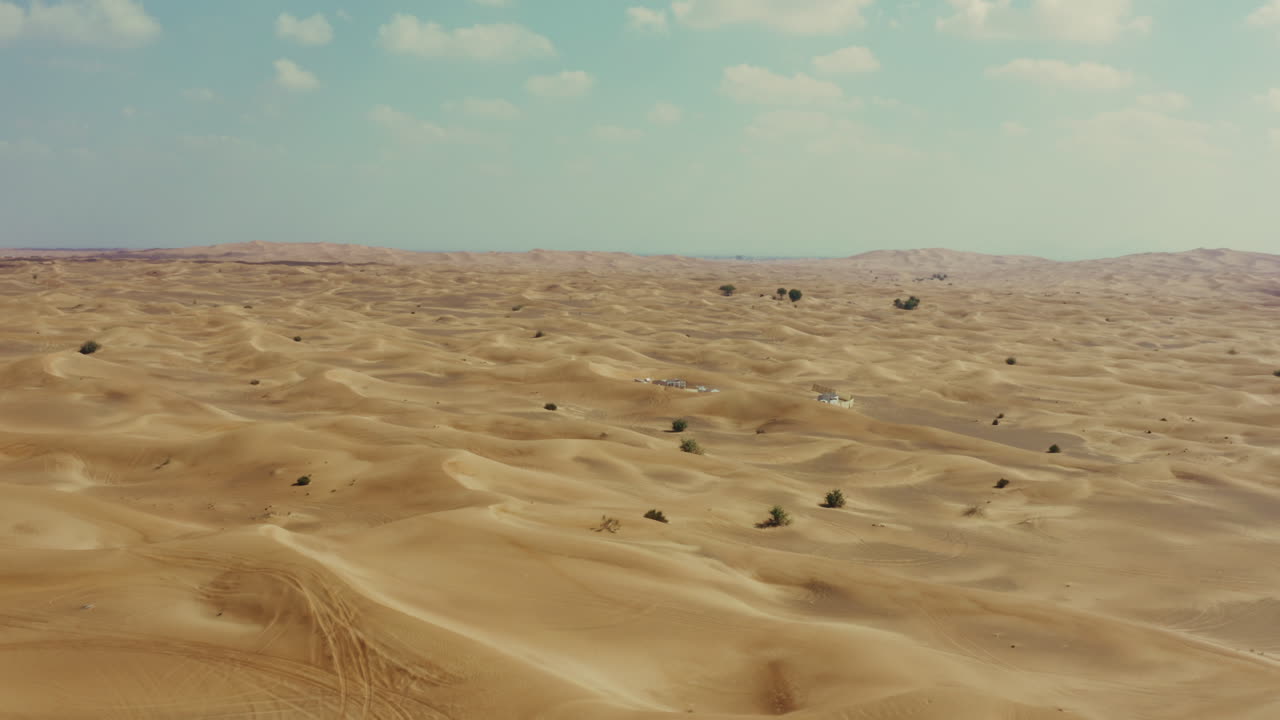 Dolly in aerial shot of arid desolate desert with yellow sand Dunes
