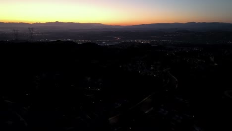 Aerial-View-of-Santa-Clarita,-Los-Angeles-CA-USA-After-Sunset,-Orange-Skyline-and-Twilights-Above-Homes,-Drone-Shot