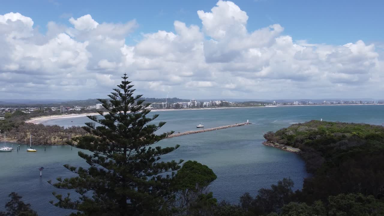 4K aerial view of a bay and a beautiful curved beach in the background