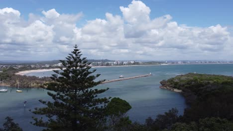 4k aerial view of a bay and a beautiful curved beach in the background