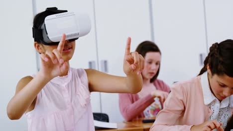 Schoolgirl-using-virtual-reality-headset-in-classroom