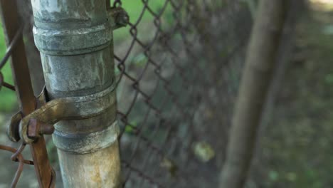 abandoned baseball field team bench behind rusty wire fence