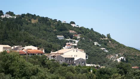 view of residential buildings and apartments nestled on the mountainside of corfu island