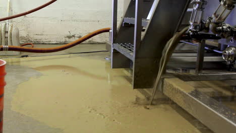 Close-up-of-beer-tank-leaking-during-beer-manufacturing-in-fabric