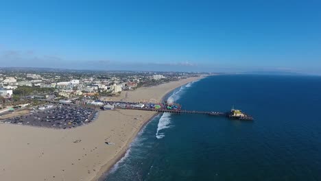 flying over santa monica beach and towards santa monica pier on summers day