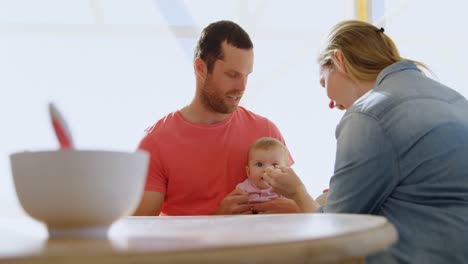 parents feeding their baby boy 4k