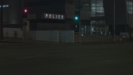 panning upwards shot revealing the police headquarters with cars driving past