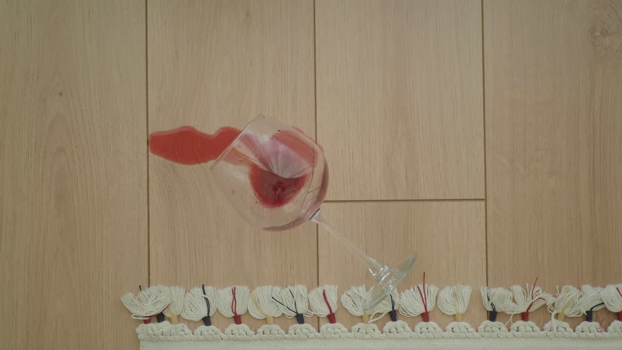 Spilled Red Wine Glass on Wooden Floor