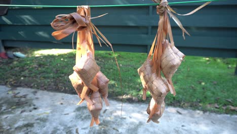 hanging ketupat to drain the water after boiled it. ketupat is special food during islamic holidays in indonesia