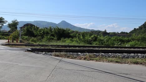 a vehicle crosses a rural train track intersection.