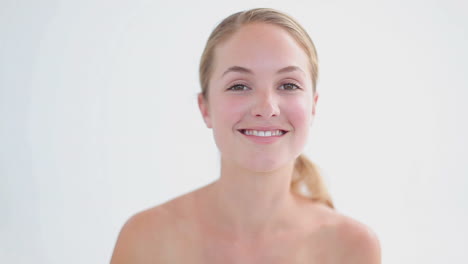 smiling woman using a pair of tweezers