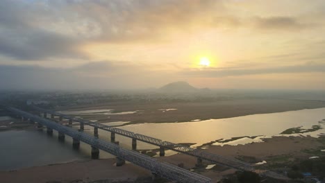 majestic aerial drone shot of vijayawada city during sunrise, with a view soaring above the scattered clouds.