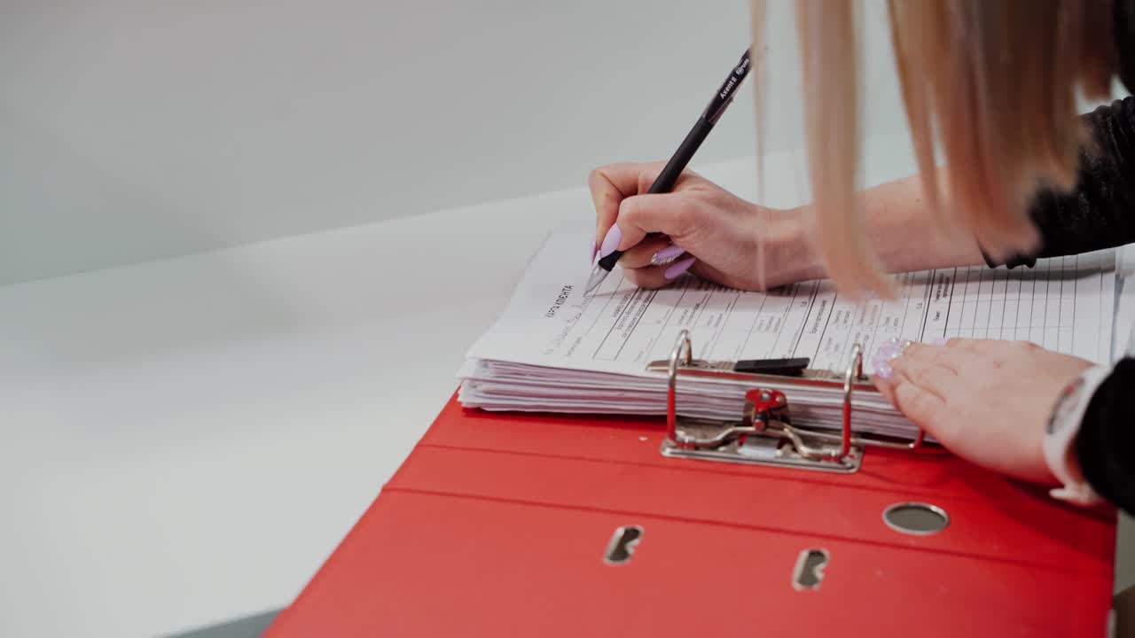 Woman hand filling form. Close up of woman hand writing in document