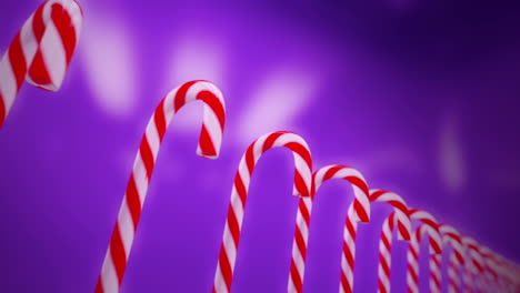 Hard-cane-shaped-candy-sticks-with-traditional-white-and-red-stripes,-flavored-with-peppermint-is-very-popular-sweet-during-the-Christmas-holidays.-Animation-of-candies-standing-in-array.-Loopable.-HD