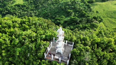 A-breathtaking-aerial-shot-of-Bote-Lighthouse-in-Catanduanes,-with-a-downward-tilt-revealing-tourists-enjoying-the-stunning-view