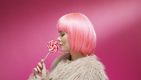 close up of a beautiful woman wearing a pink wig and turning her face to the camera