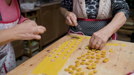 crop senior woman cooking tortellini at home