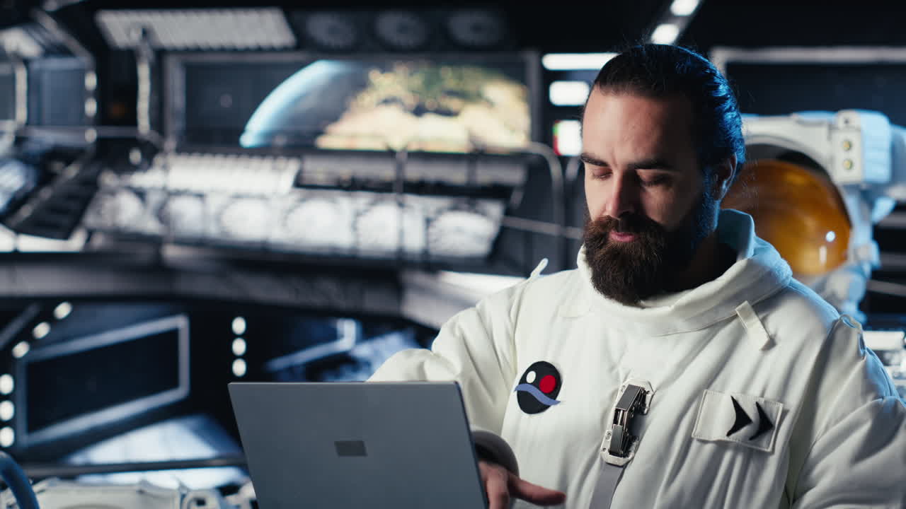 Astronaut using laptop to verify mission parameters after completing expedition