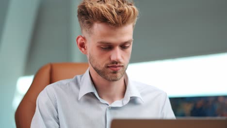focused productivity: young businessman concentrated on notebook, engaged in writing
