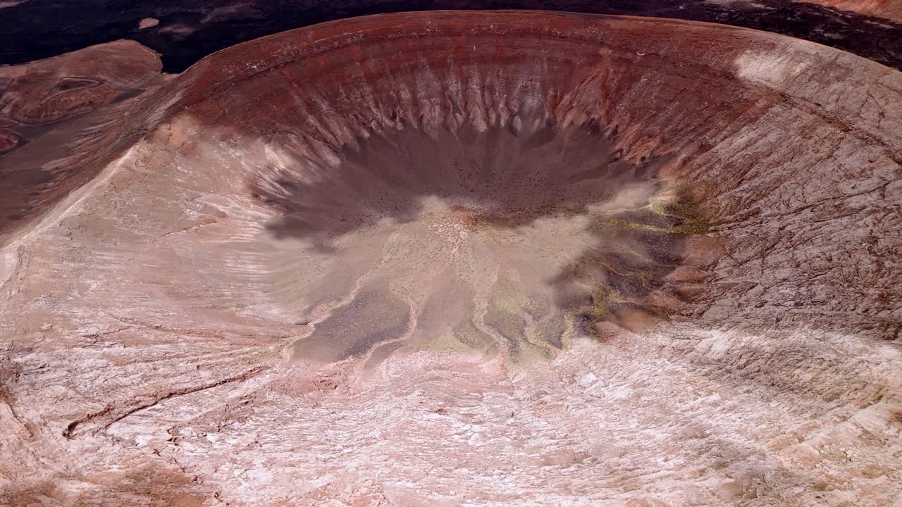 Impressive aerial drone footage of Caldera Blanca, the largest volcanic crater in Lanzarote measuring approximately 1,200 meters in diameter. Canary Islands, Spain.