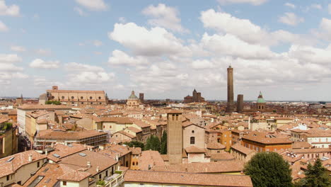colorful cityscape of bologna old town with church and towers, aerial ascennd drone view