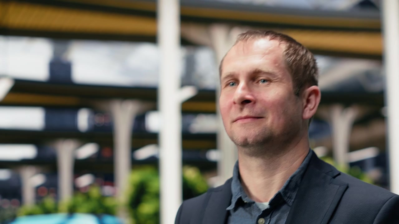 Close up up of upbeat businessman walking inside bus terminal