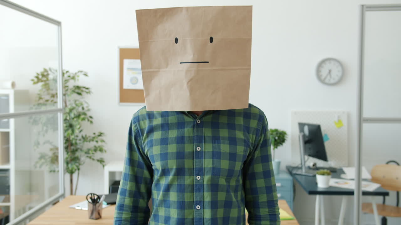 Man with Paper Bag over Head in Office