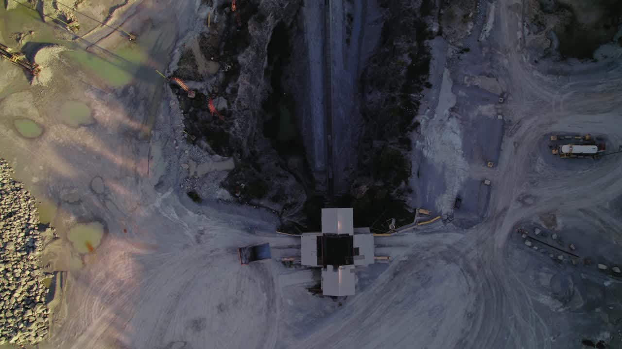 Heavy-Duty Dump Truck Exiting Crusher House at Thornton Illinois Quarry. Top down aerial. USA