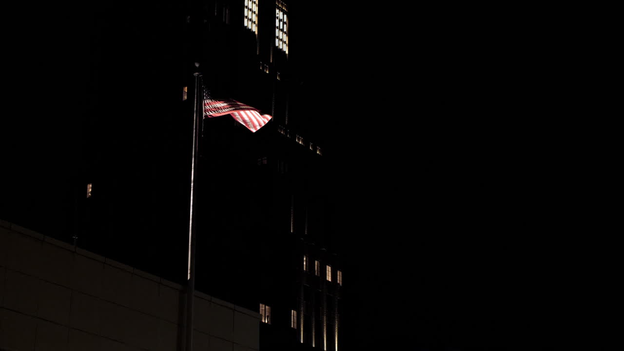 American flag waving on top of a manhattan building