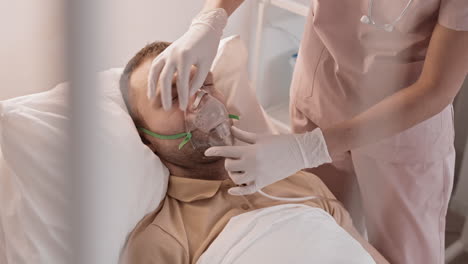 nurse adjusting oxygen mask on patient