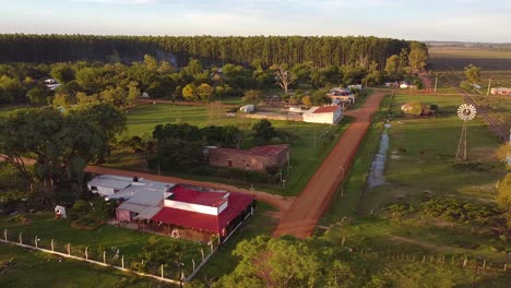 Aerial-view-of-rural-area-and-dirt-road-in-Guavirari-with-windmill