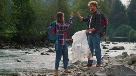 volunteers collecting bottles in bag