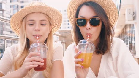 two women enjoying drinks outdoors