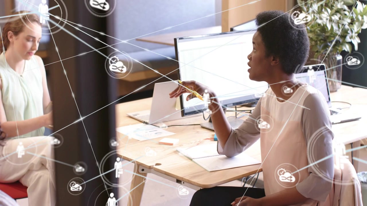 Right woman talking, left peer handling green orb spreading network icons, mapping business ties