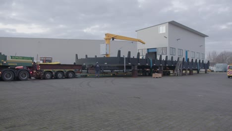 newly build ship getting loaded onto flatbed, getting ready to be moved to launching pad