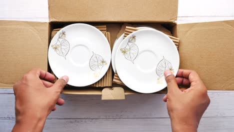 unpacking a box of dishes