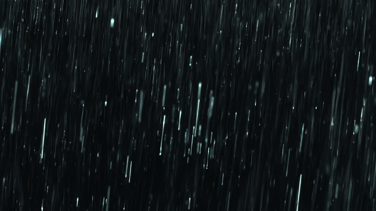 Heavy rain pours against a black background with close-up droplets splashing on impact. A seamless, loopable practical VFX element perfect for storm atmospheres, dramatic scenes and cinematic overlays