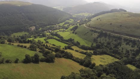 aerial view horseshoe pass lush scenic misty mountain valley picturesque rural countryside forward moving