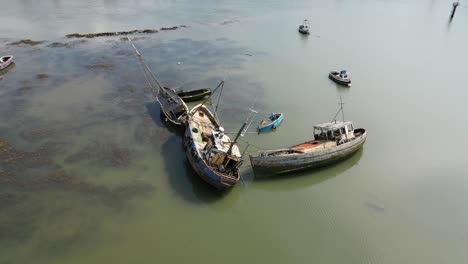 rusted shipwrecks in calm murky water of the river wyre at fleetwood docks lancashire uk