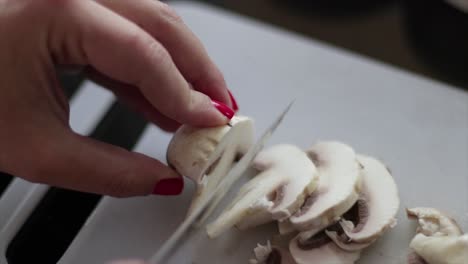 Chopping-mushrooms-on-a-chopping-board