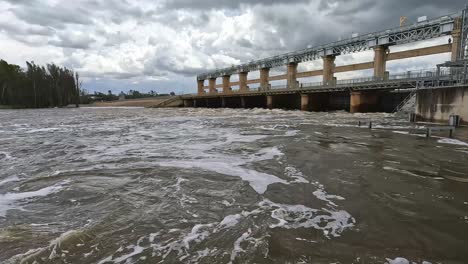 view across the swollen and swiftly flowing murray river at the yarrawonga weir bridge during flooding conditions