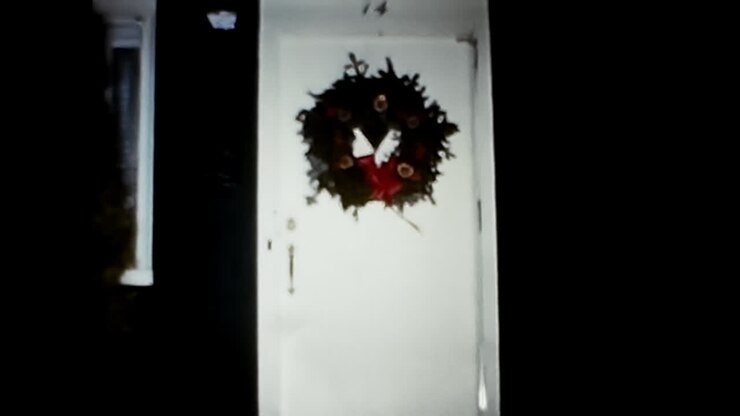 Man Standing in Front of White Door. CIRCA USA - 1970s: A 1970s archival photo of a man standing in front of a white door in the USA.